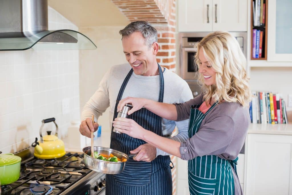 Couple enjoying their kitchen remodel after avoiding these mistakes